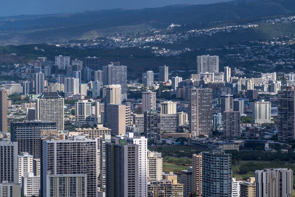 Photo by Cyrill Stunning aerial view of Honolulu's urban skyline featuring modern skyscrapers under a clear sky.