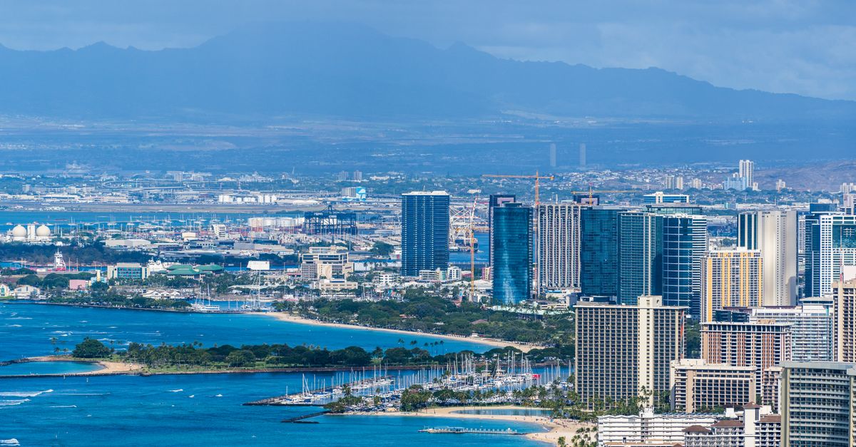 Photo by Cyrill Stunning aerial view capturing Honolulu's cityscape with coastal beauty and distant mountains.
