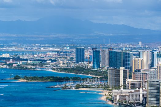 Photo by Cyrill Stunning aerial view capturing Honolulu's cityscape with coastal beauty and distant mountains.