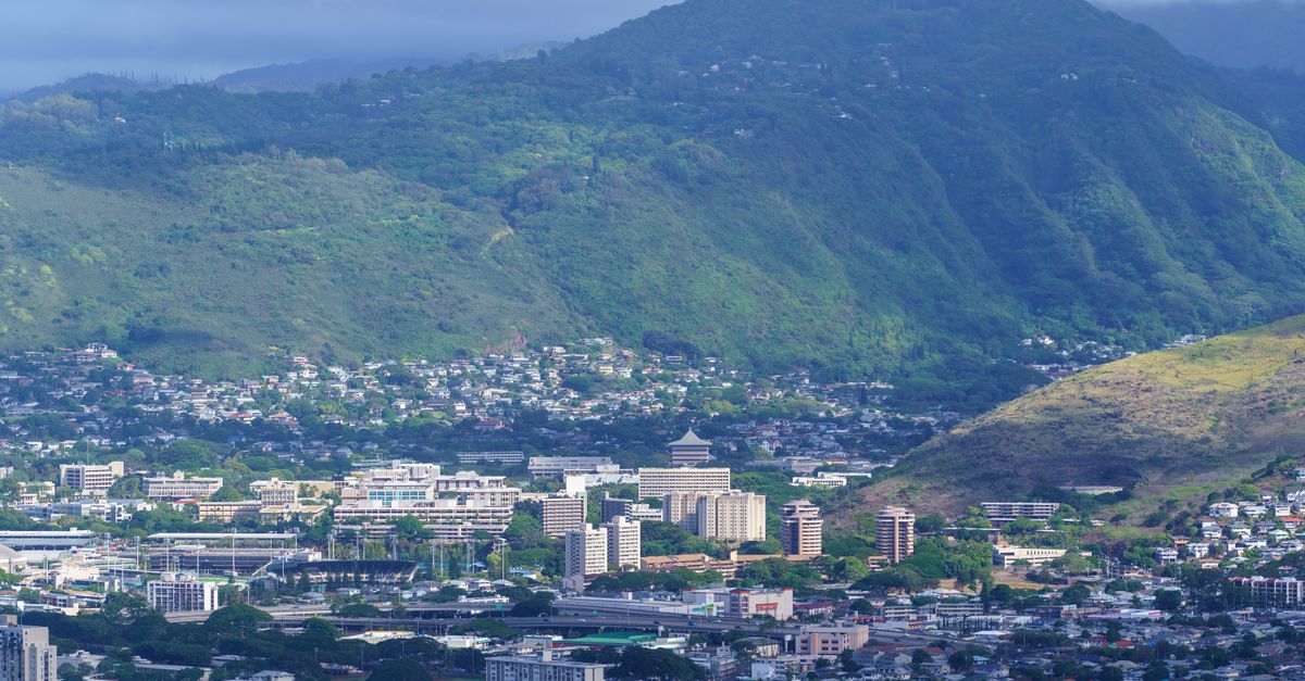 Photo by Cyrill Aerial view of Honolulu cityscape against lush green mountains, Hawaii.