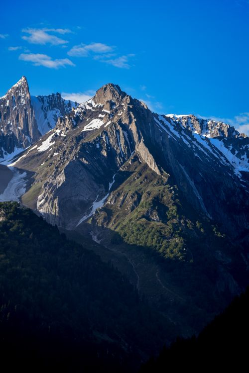 Free Stunning snow-capped mountain peaks with clear blue sky, captured in winter season. Stock Photo
