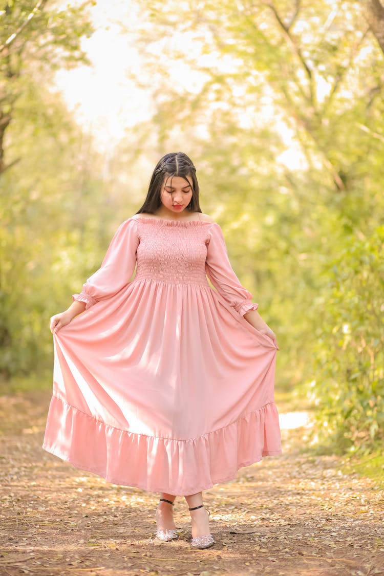 Young Woman In A Pink Dress Posing Outdoor