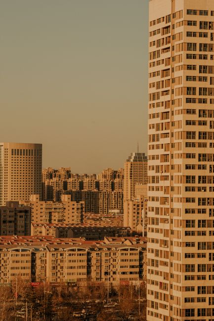 Stunning aerial view of a modern cityscape with skyscrapers during sunset.