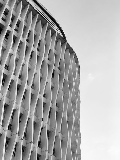 Free A black and white photo showcasing modern abstract architectural design with a unique facade. Stock Photo