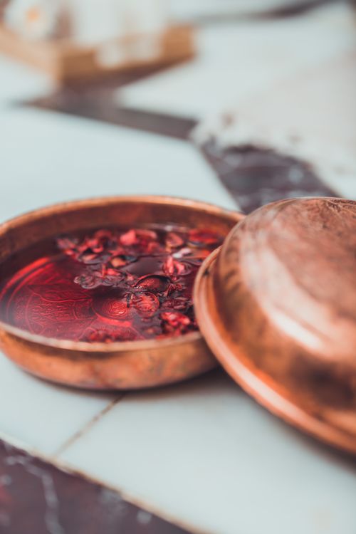 Free Close-up of a copper bowl with dried petals in water, evoking a sense of luxury and relaxation. Stock Photo