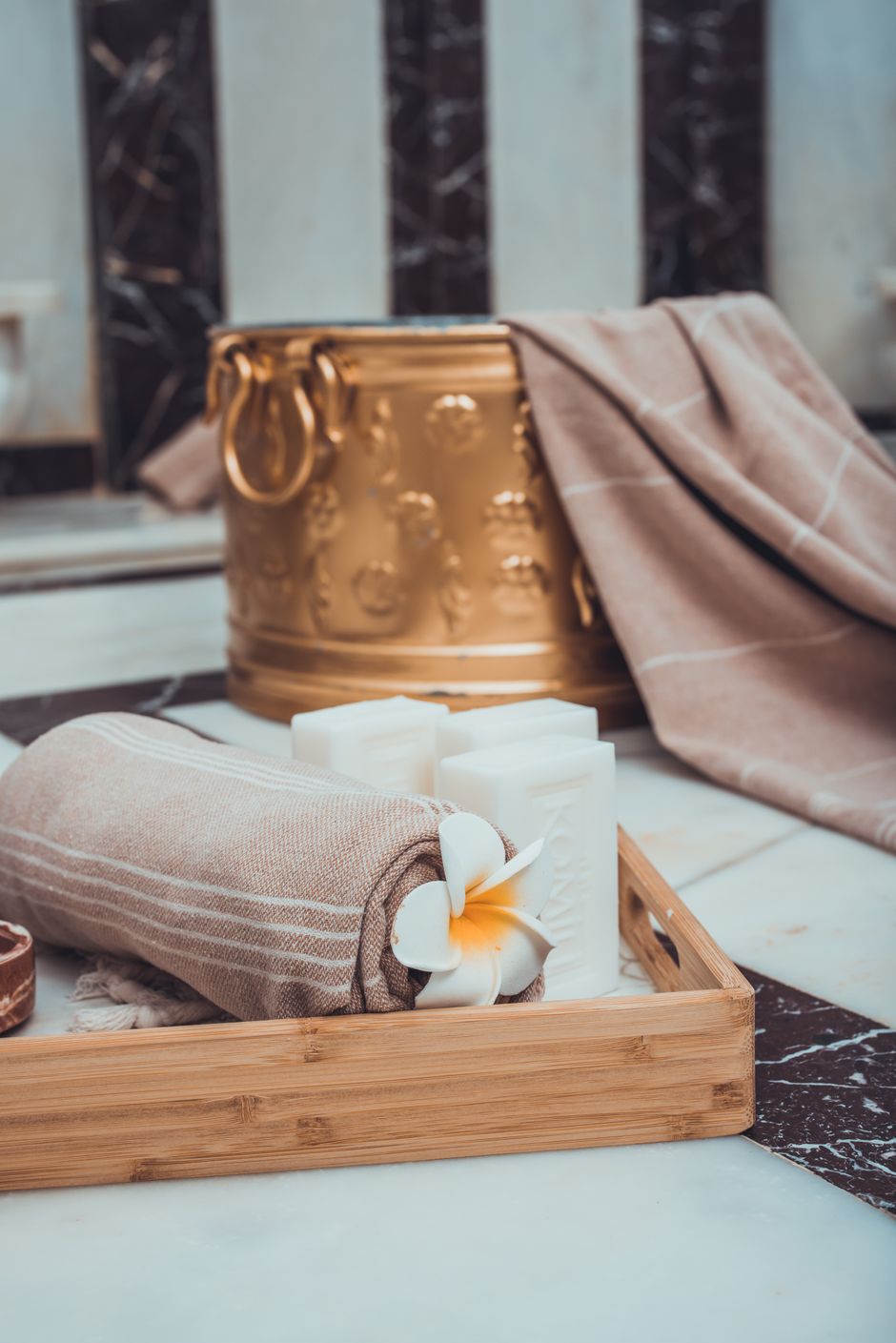 Experience relaxation with towels and candles in a serene Turkish bath setup.