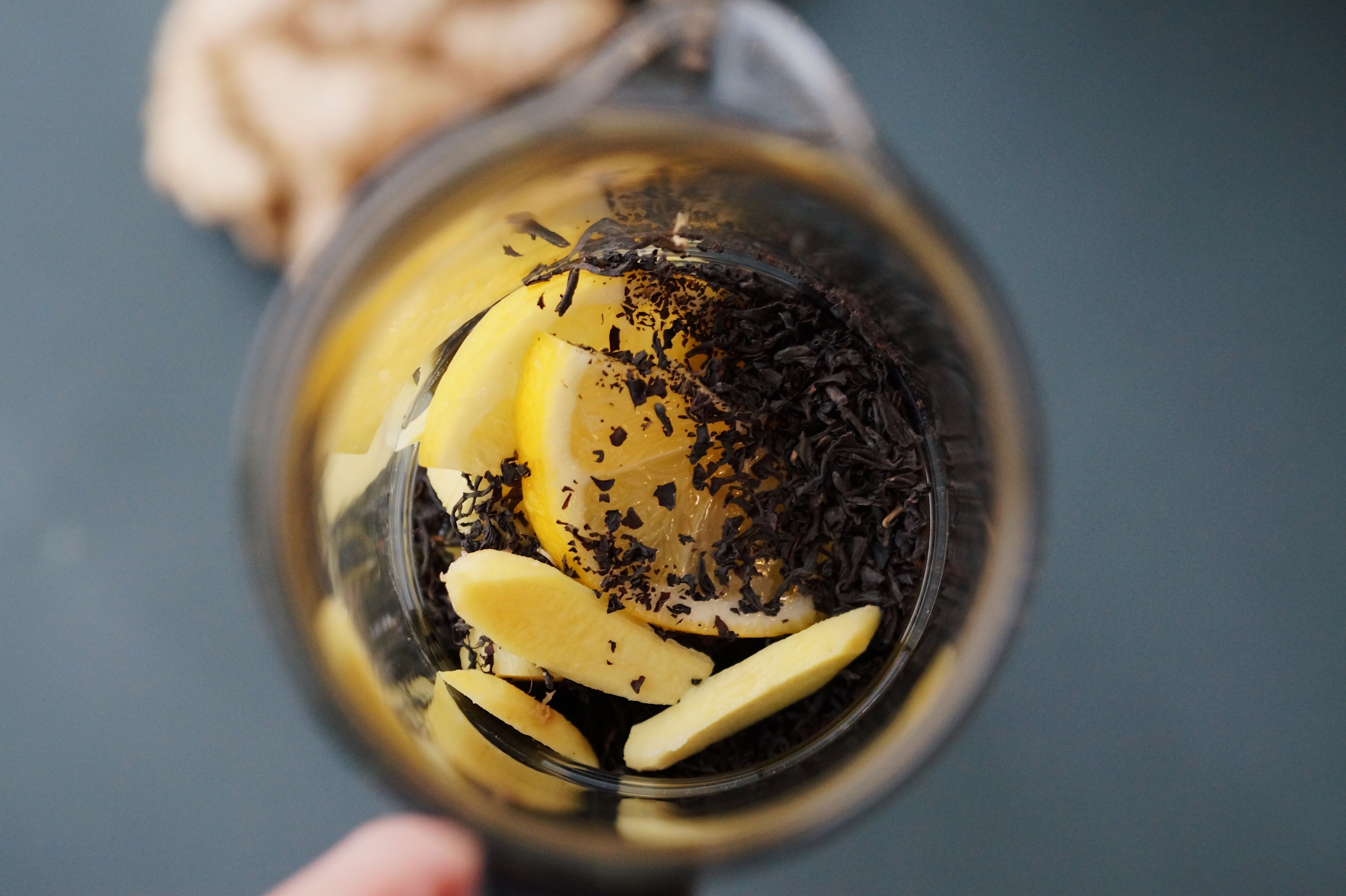 Free A fresh lemon and ginger tea infusion seen from above in a glass teapot. Stock Photo