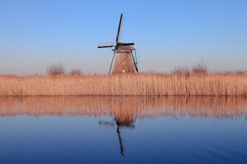 Wooden Windmill Reflecting in River