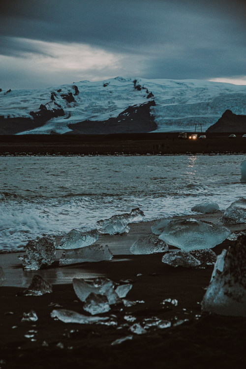 Free Mesmerizing view of glacial ice scattered on Iceland's famous black sand beach at twilight. Stock Photo
