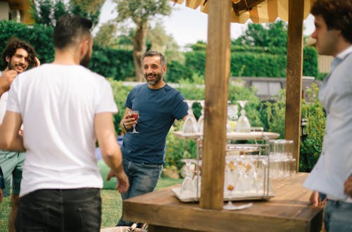 Free Photo of Men Talking at a Garden Party Stock Photo