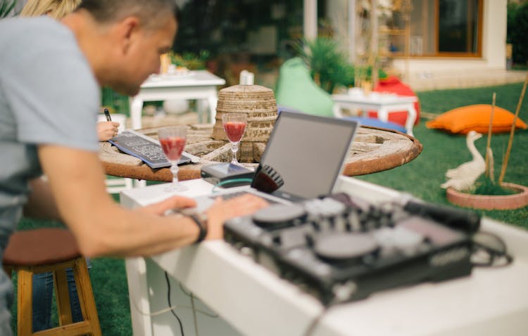 Man Working On Laptop In Garden