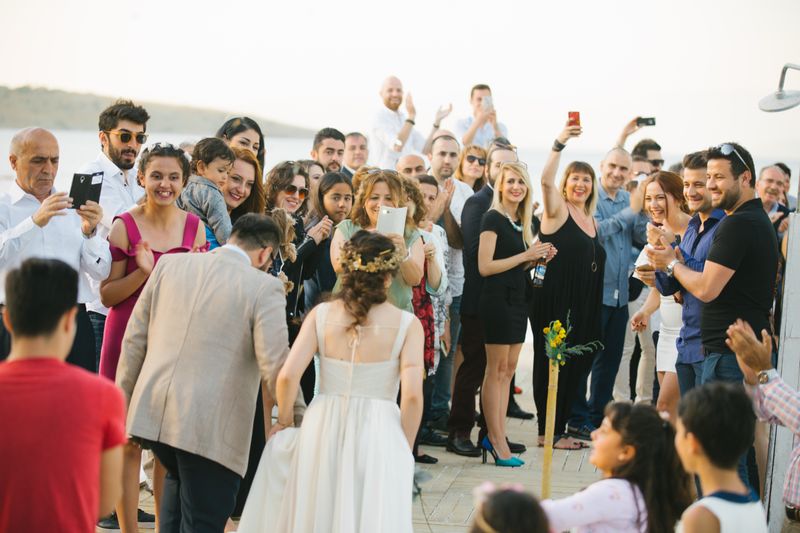 Bride and groom walking past a crowd of wedding guests
