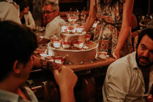 Free Guests enjoy desserts and conversation at a lively dinner party. Stock Photo