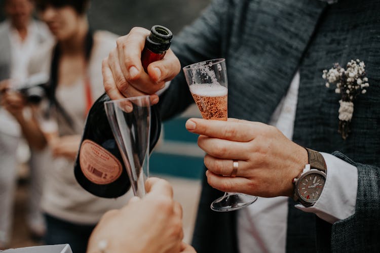 Man Pouring Champagne Into A Wine Glass