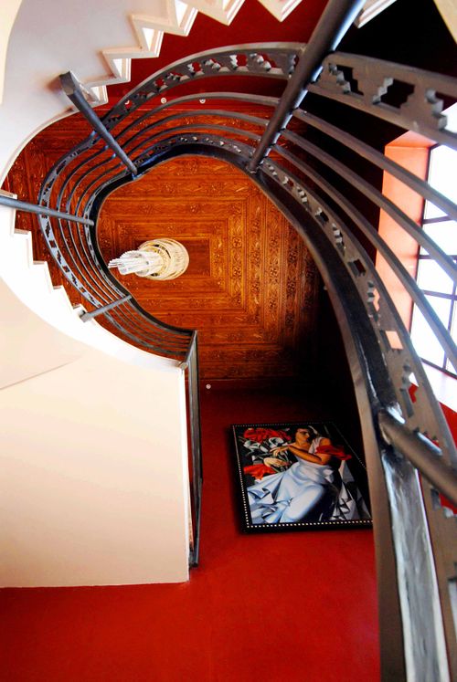 Free Elegant spiral staircase with ornate design and red walls in Marrakech. Stock Photo