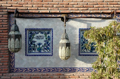 Retro Ornate Lamps Hanging on Brick Wall