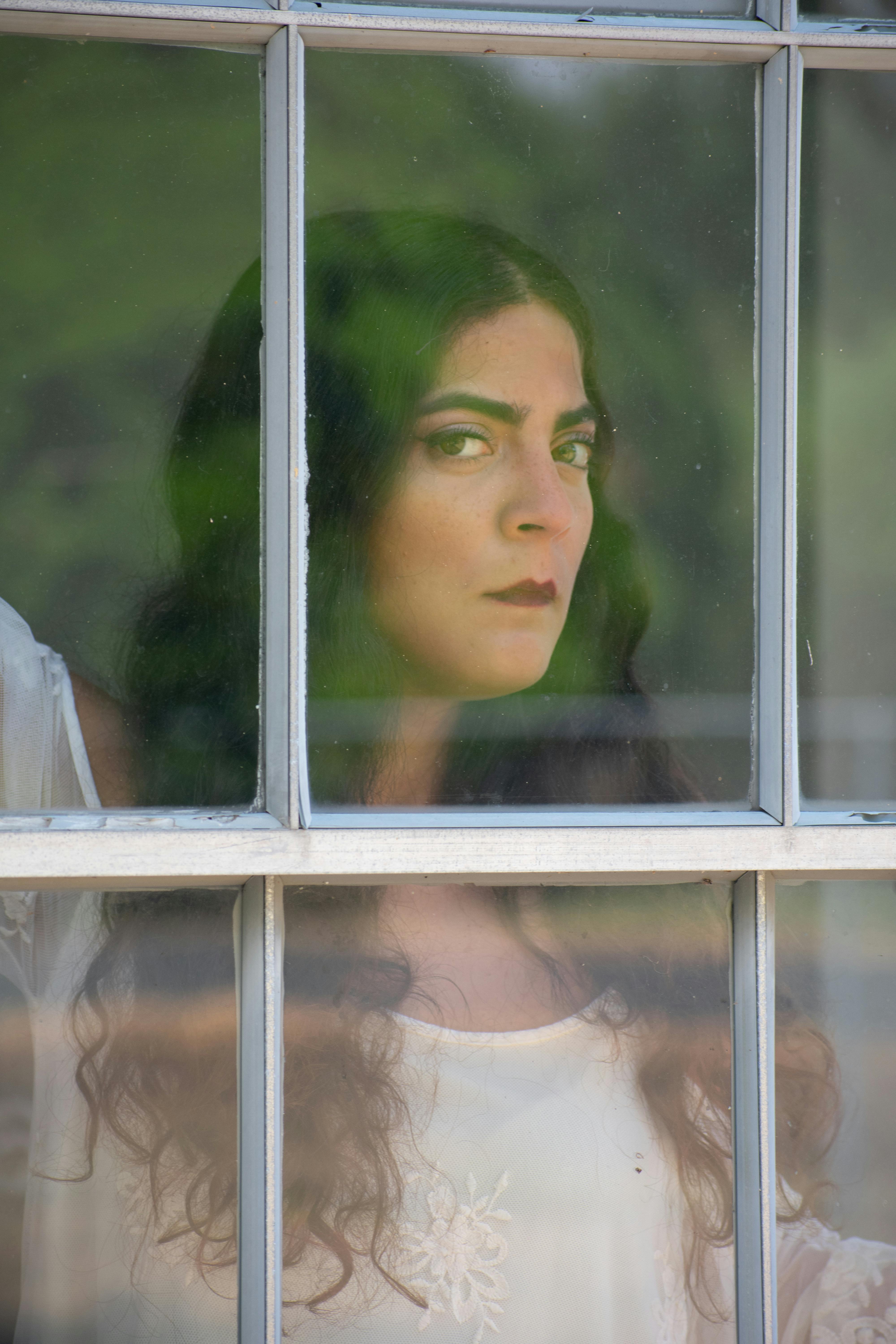 Woman Behind a Window Pane · Free Stock Photo