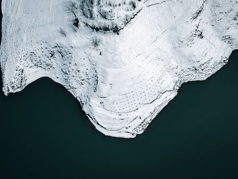 Aerial Shot of Sea and a Snow Covered Mountains 