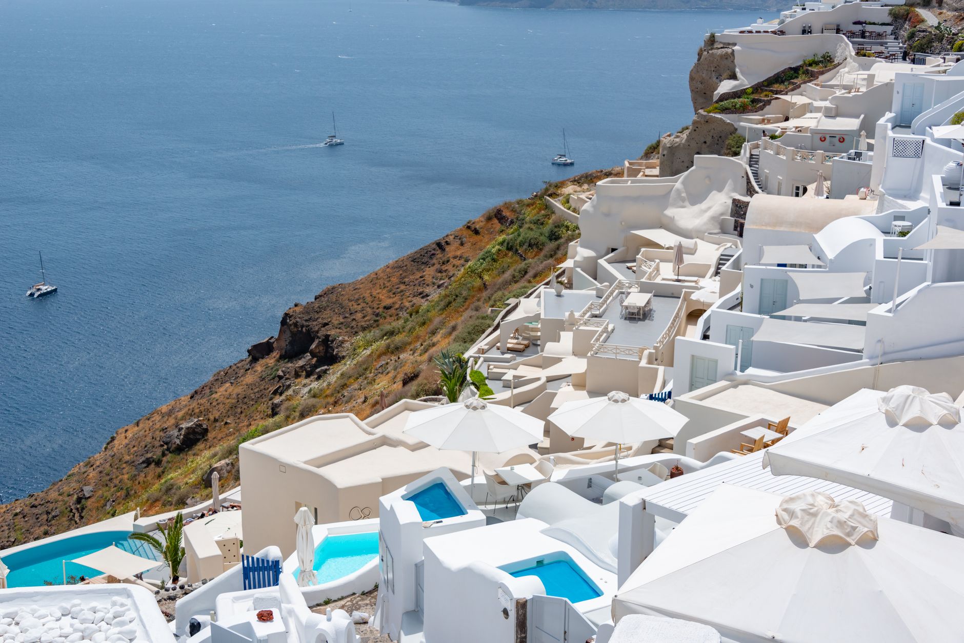 Stunning view of Santorini's white architecture with the Aegean Sea in the background. Perfect for travel enthusiasts.