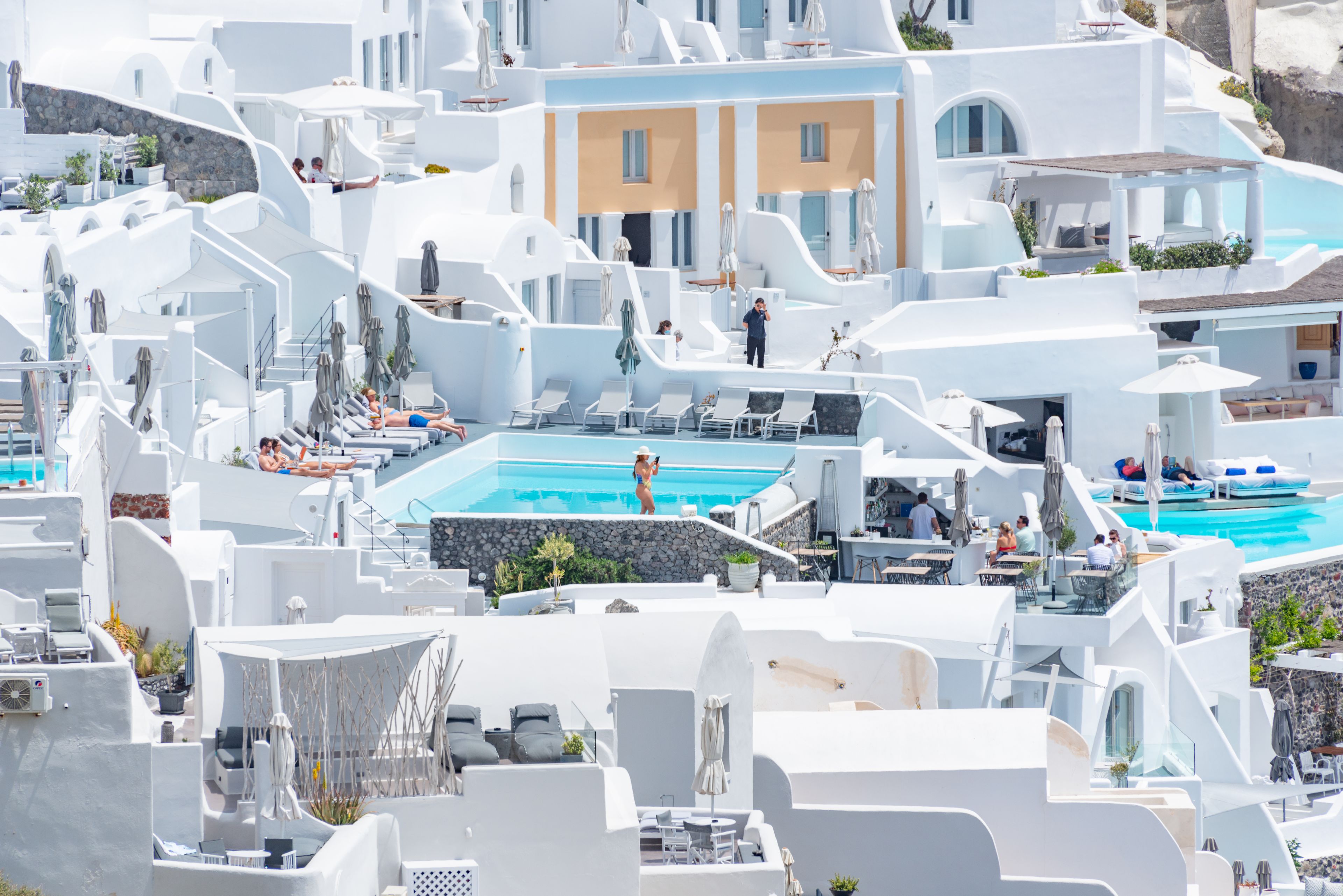 Clifftop infinity pool at a luxury caldera-view hotel in Imerovigli, Santorini at sunset