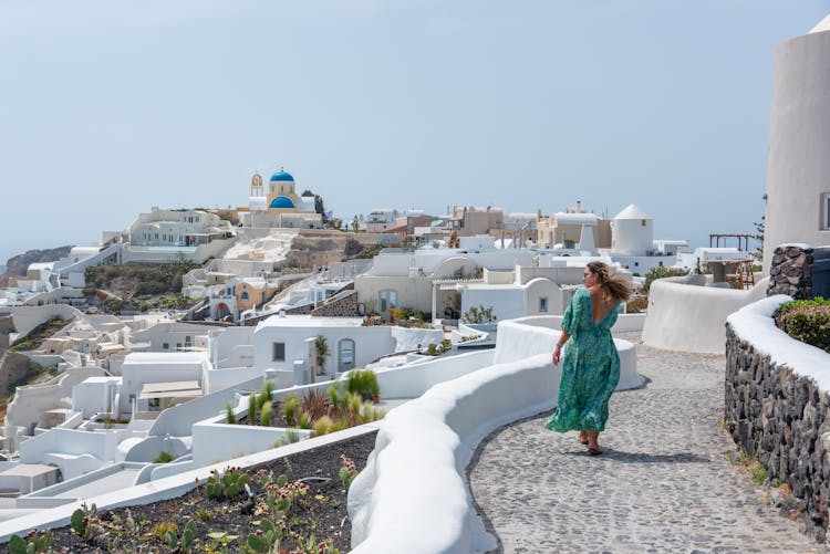 Woman Walking On Street On Santorini Island