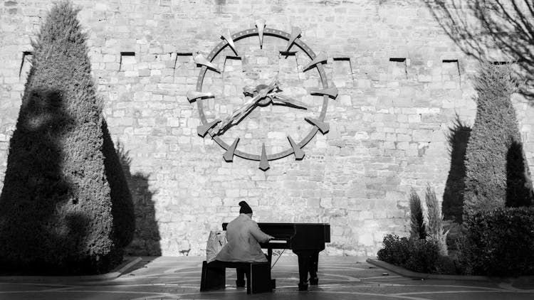 Elderly Man Playing On Piano In Park