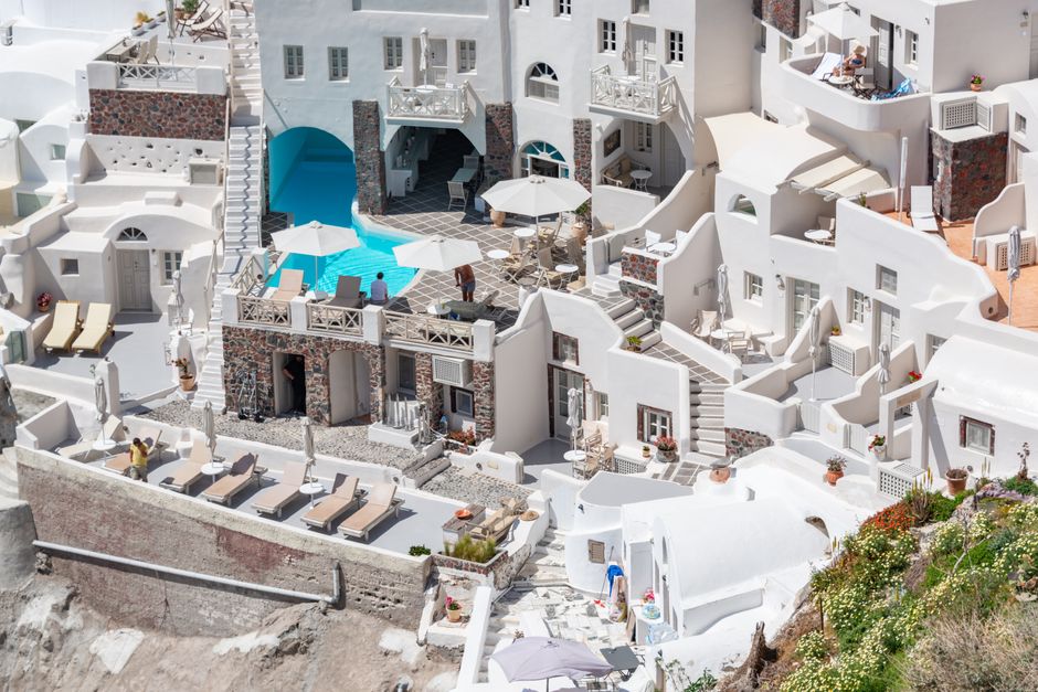 Luxurious infinity pool overlooking the caldera in Santorini, Greece.