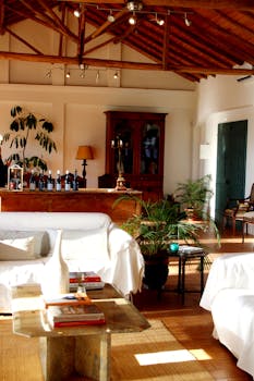 Brightly lit living room with wooden ceiling and stylish furniture, perfect for relaxation.