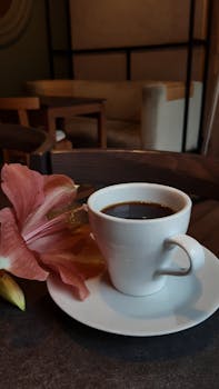 Aromatic coffee in a cozy Dnipro café with a beautiful flower.