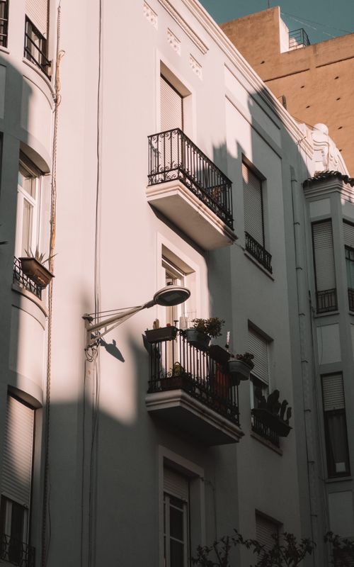 Free Elegant residential balconies in Castellón de la Plana, Spain, captured in warm evening light. Stock Photo