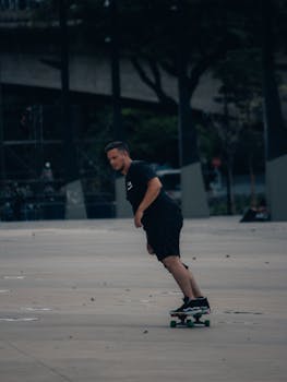 Man skateboards along an urban path, showcasing action and leisure in city life.