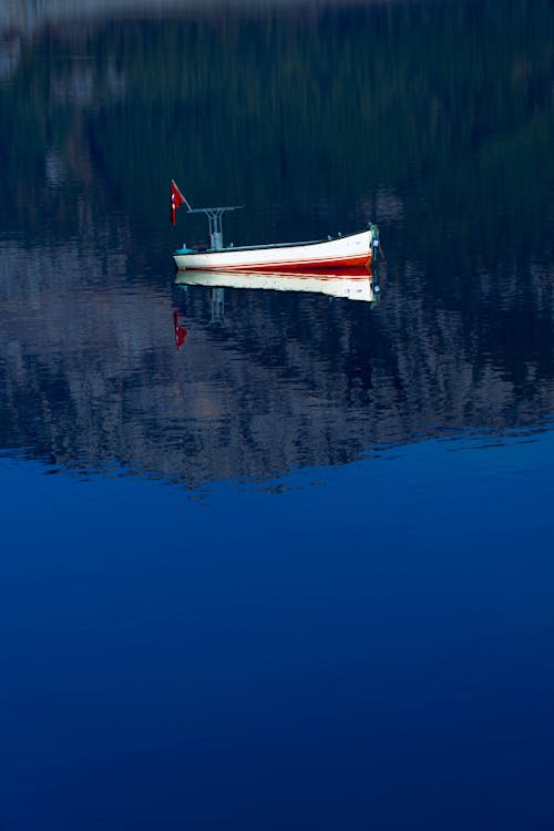 Wooden Boat in Blue Water in Evening