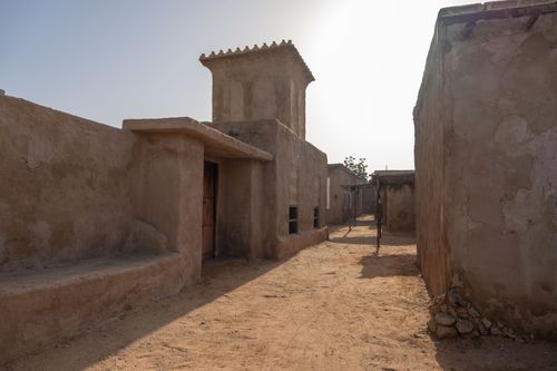 Free Explore a historic adobe townscape under the harsh desert sun, capturing timeless architecture. Stock Photo