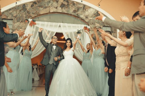 Wedding Couple Cheering among Guests