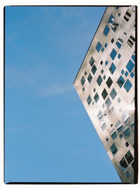 Futuristic building facade reflecting sunlight on a clear day in Tbilisi, Georgia.