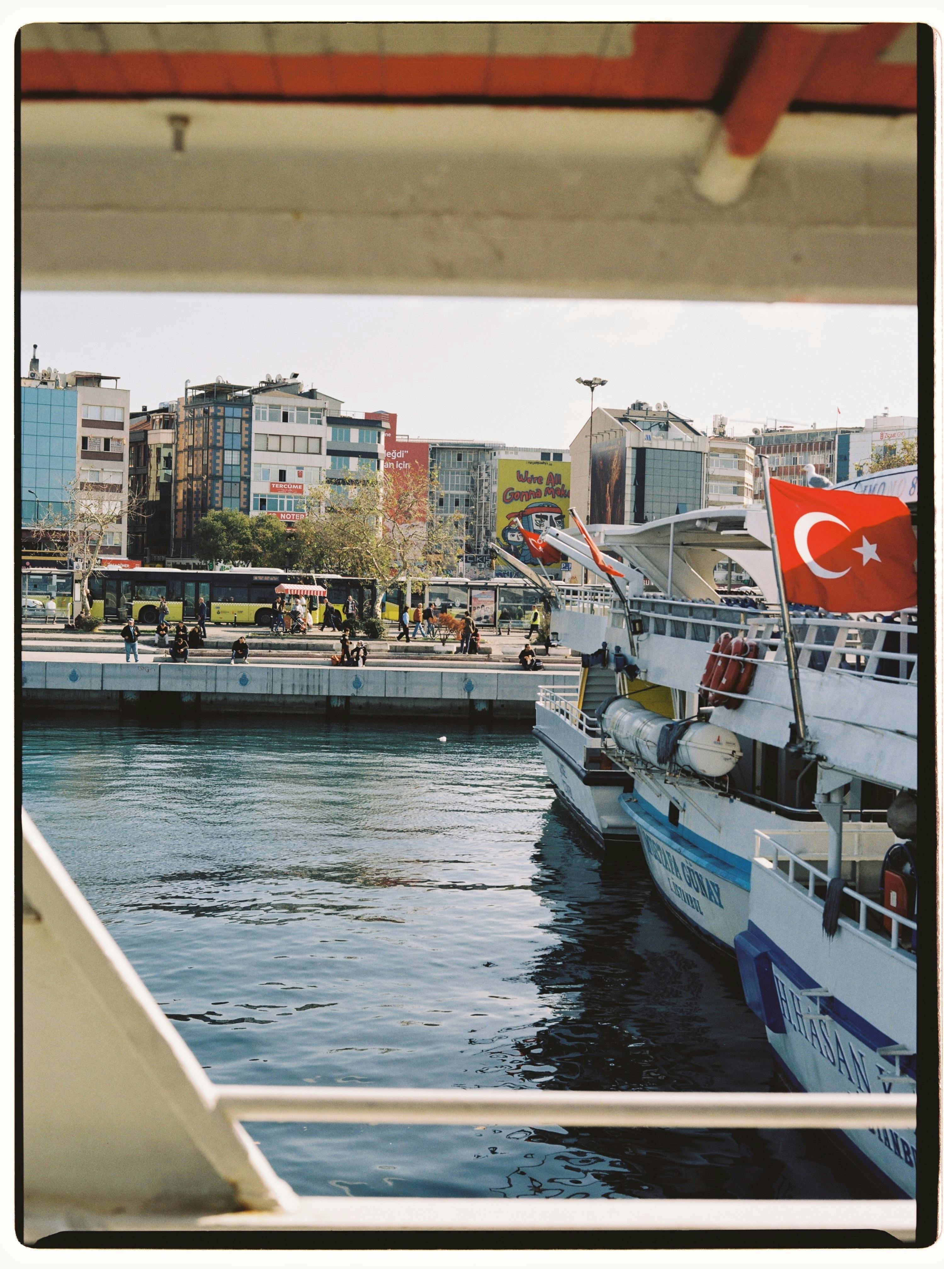 Passenger ship at a dock in Istanbul with Turkish flag, Bosphorus view.