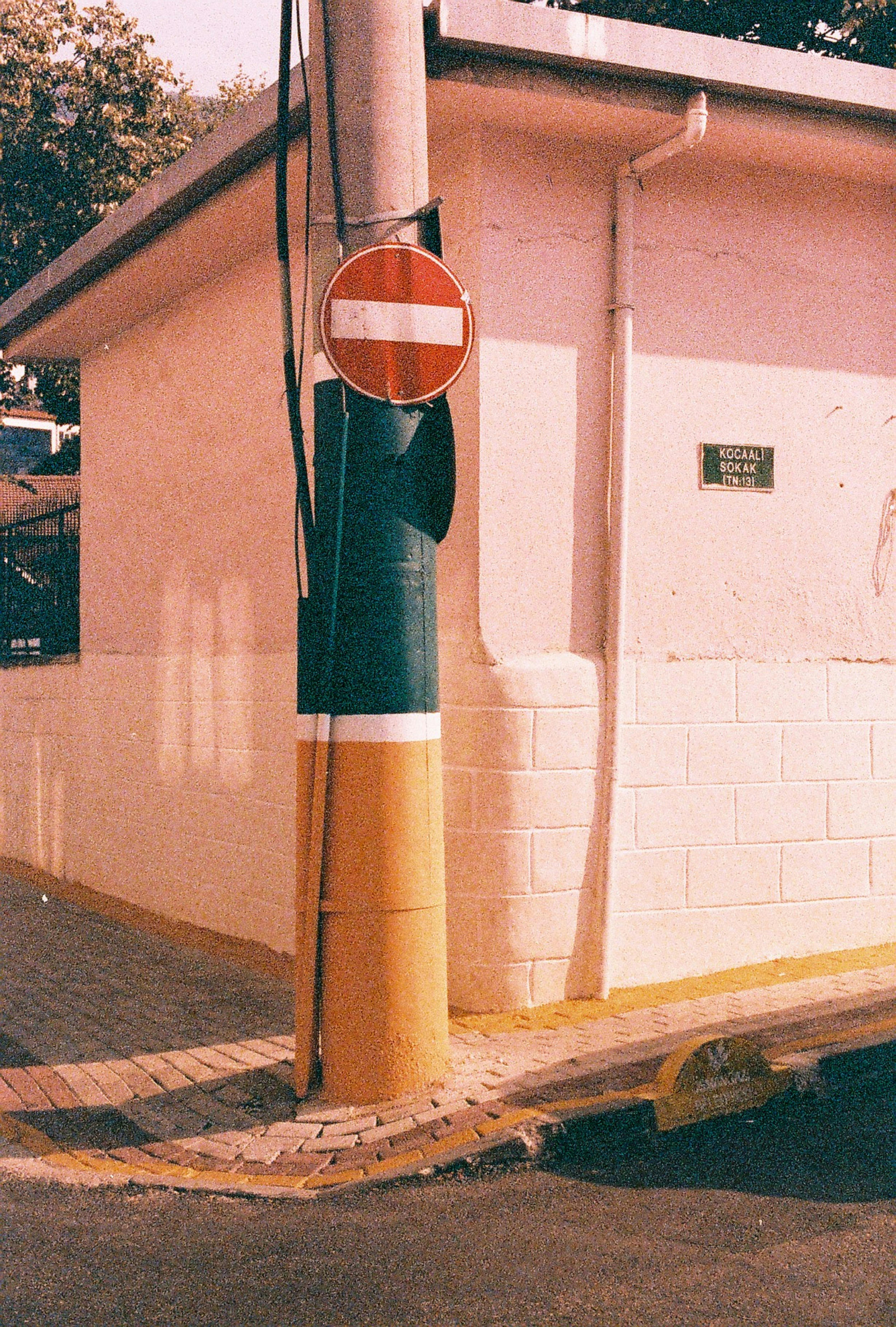 Free A vibrant street scene in Bursa featuring a colorfully painted pole and a no entry sign. Stock Photo