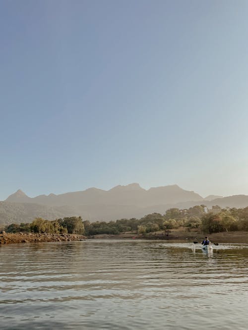 Person Sailing in Kayak on River