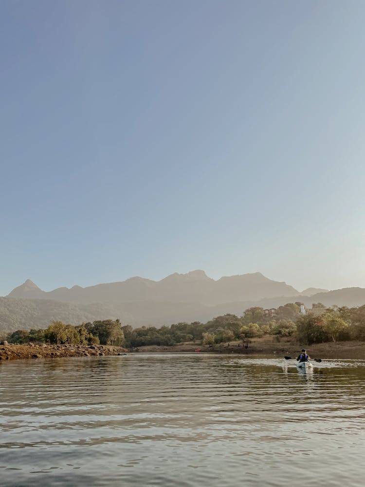 Person Sailing In Kayak On River