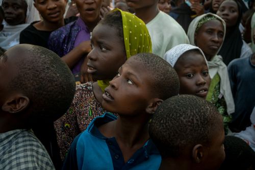 Free A diverse group of children looking up in curiosity amidst a crowd, evoking a sense of anticipation. Stock Photo