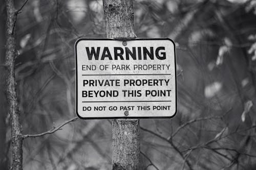  A Plaque with a Warning Attached to a Tree