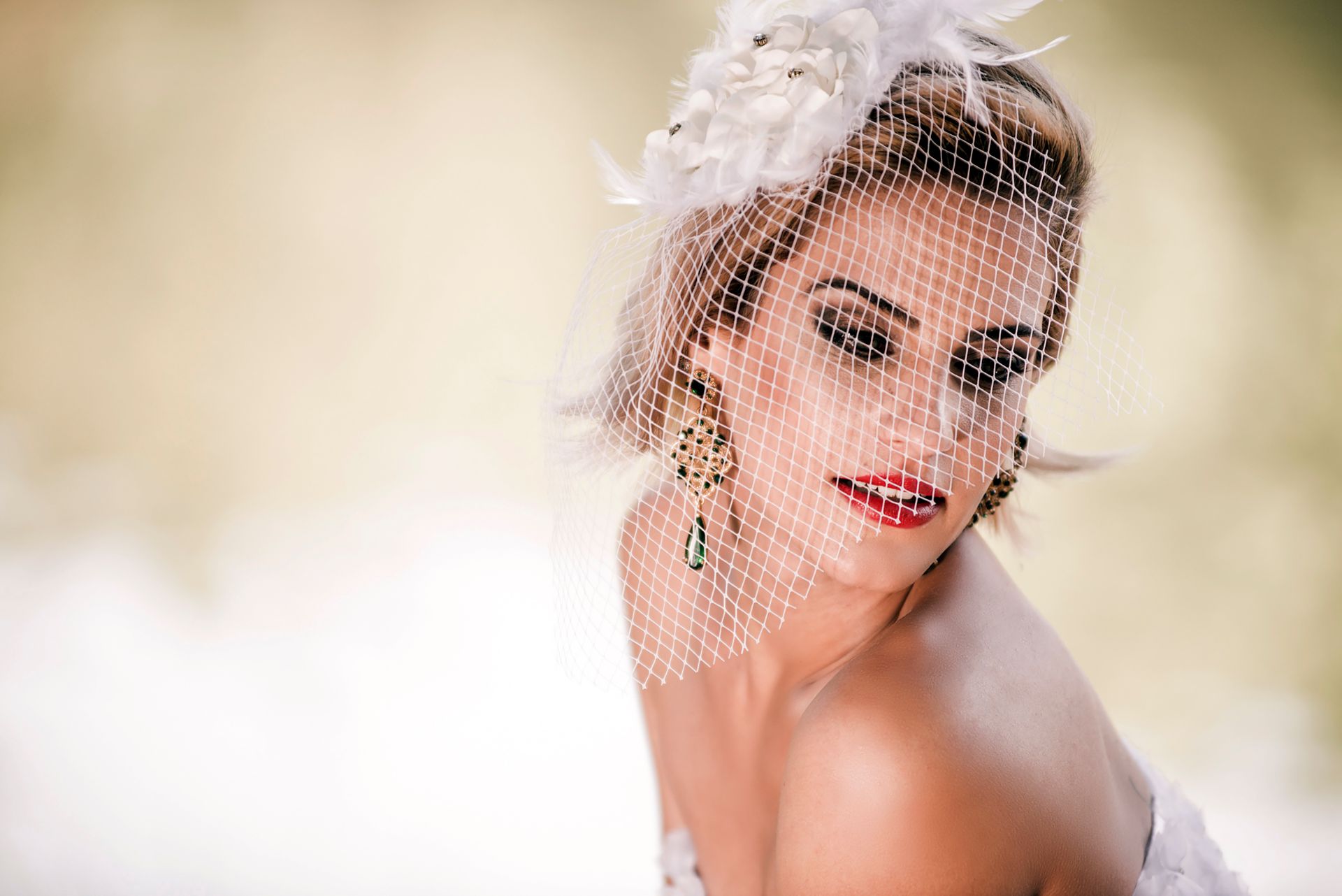 Charming portrait of a bride with a floral headpiece and veil, showcasing elegance and beauty.