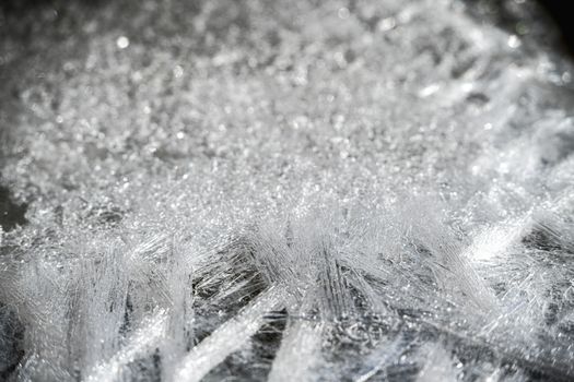 Detailed view of intricate ice crystals, showcasing winter texture and abstract patterns.