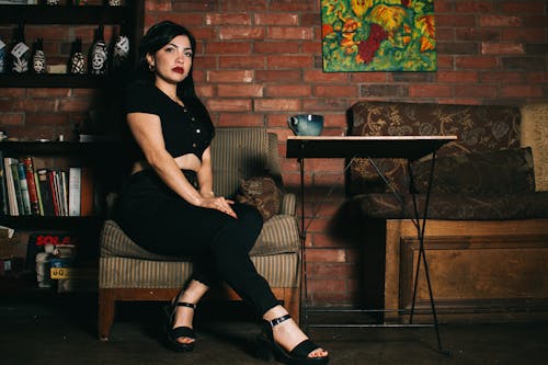 Young Brunette Sitting in an Armchair