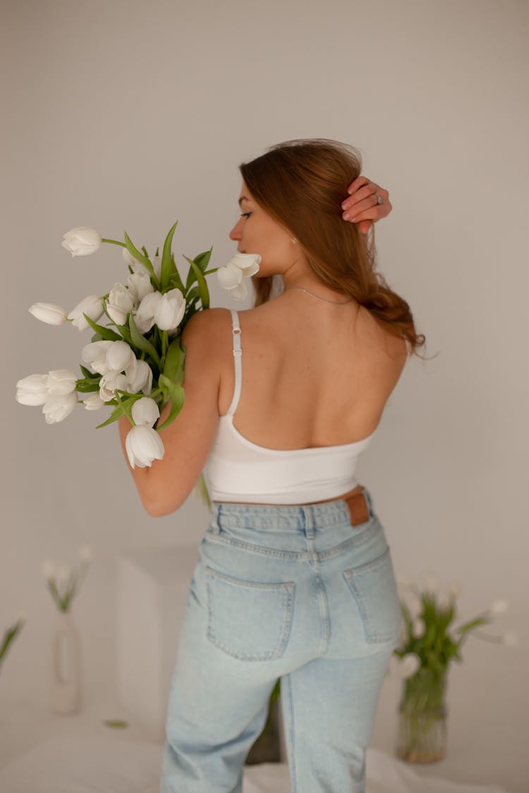 Woman Standing With Bouquet Of White Tulips