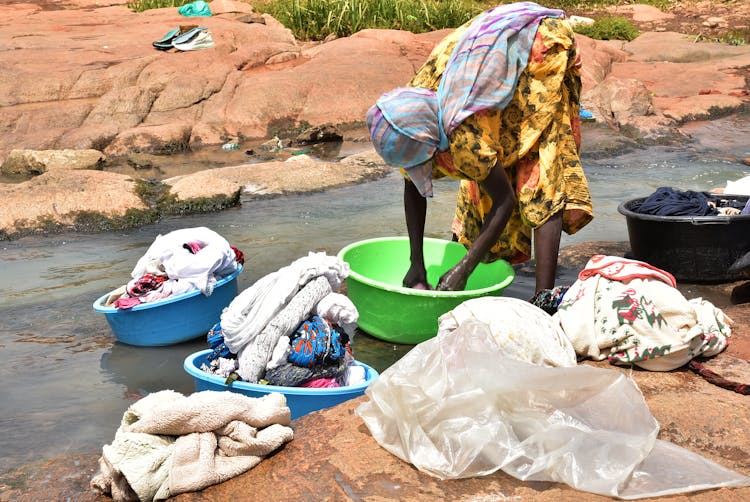 Woman Washing Clothing In A River