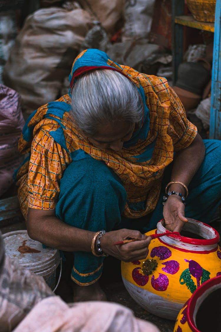 Senior Artisan Decorating A Vase