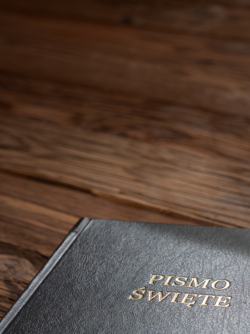 Free Close-up of a Polish Bible on a wooden background, showcasing its cover. Stock Photo
