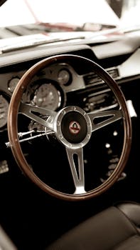 Close-up of a vintage car interior featuring a classic wooden steering wheel. Retro ambiance.