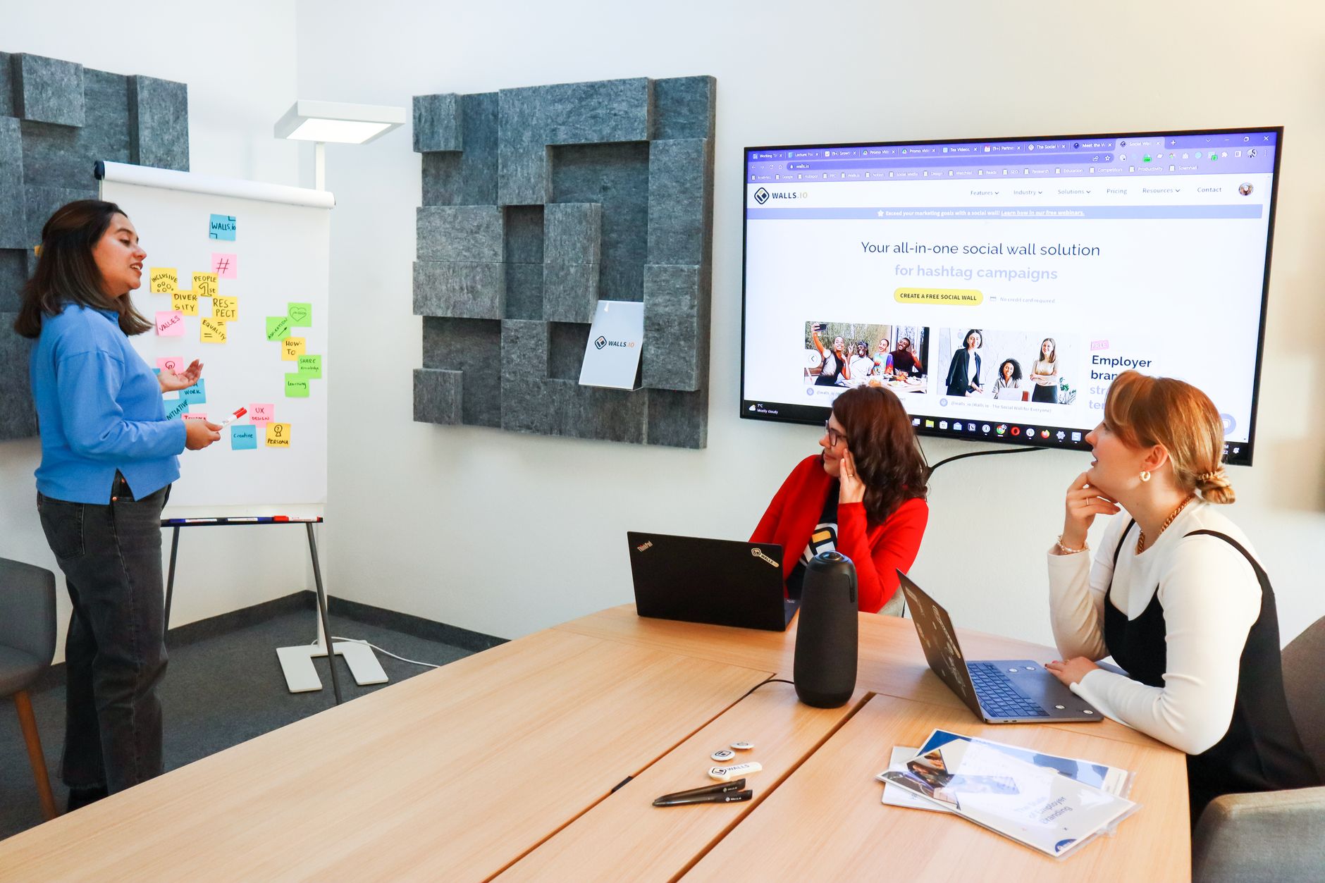 A diverse group of women having a brainstorming session in a modern office conference room.